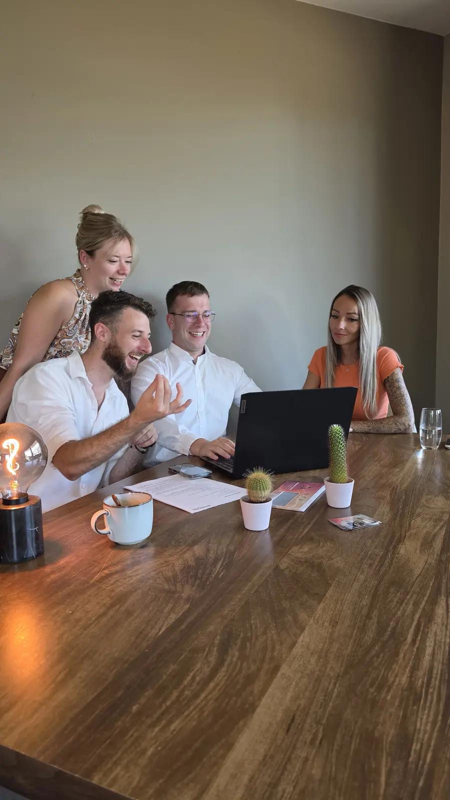 Stef, Maxim and Elke discuss automation opportunities with a customer around a laptop